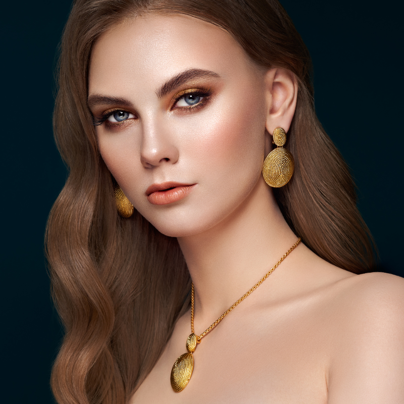 Jewellery_5 Lady stares at camera wearing gold jewellery