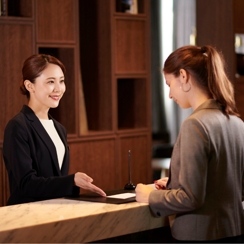 Travel grid 5 A lady checks into a hotel