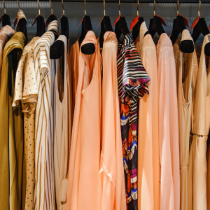 dresses hung on hangers on display in a shop