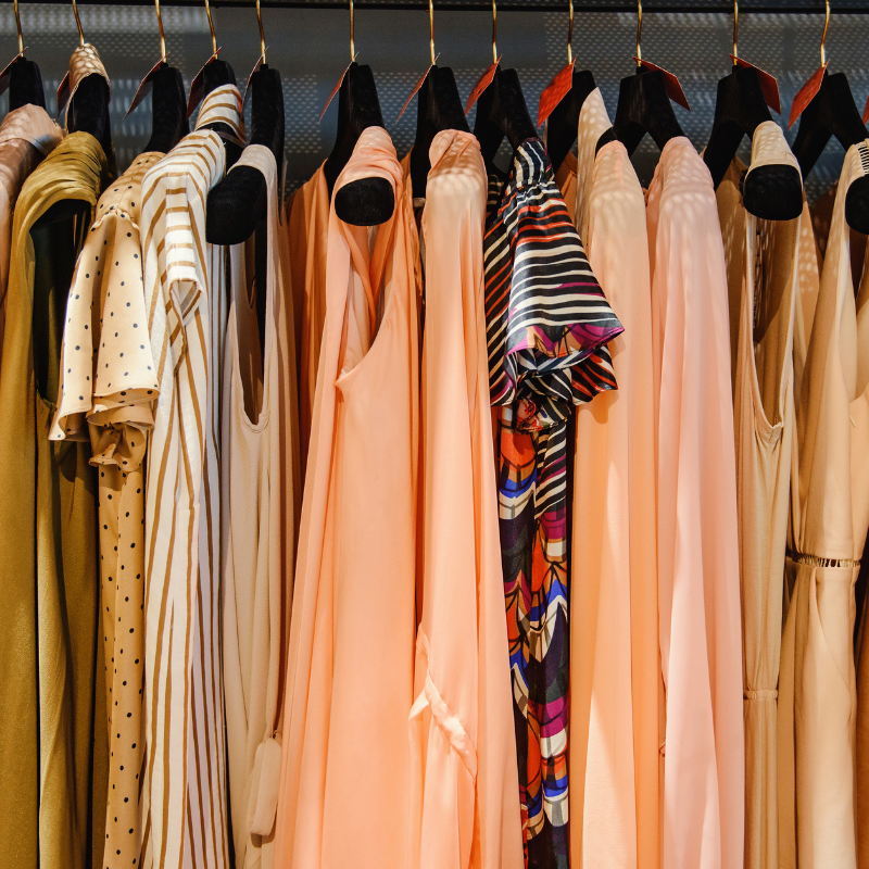 fashion grid 1 dresses hung on hangers on display in a shop