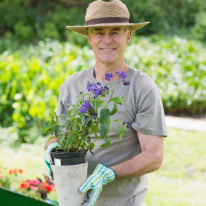 man holds potted flower
