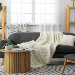a living room scene with a sofa and coffee table