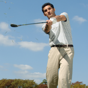 a golfer swinging an iron