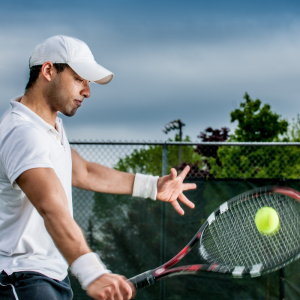 a tennis player hitting a one handed backhand