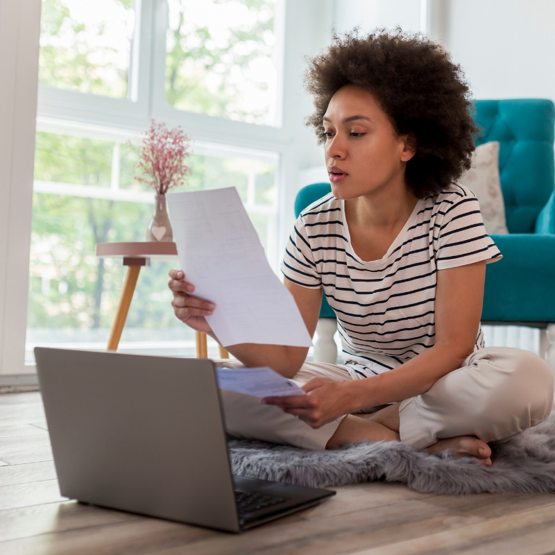 telecoms grid 6 woman with paper in front of laptop