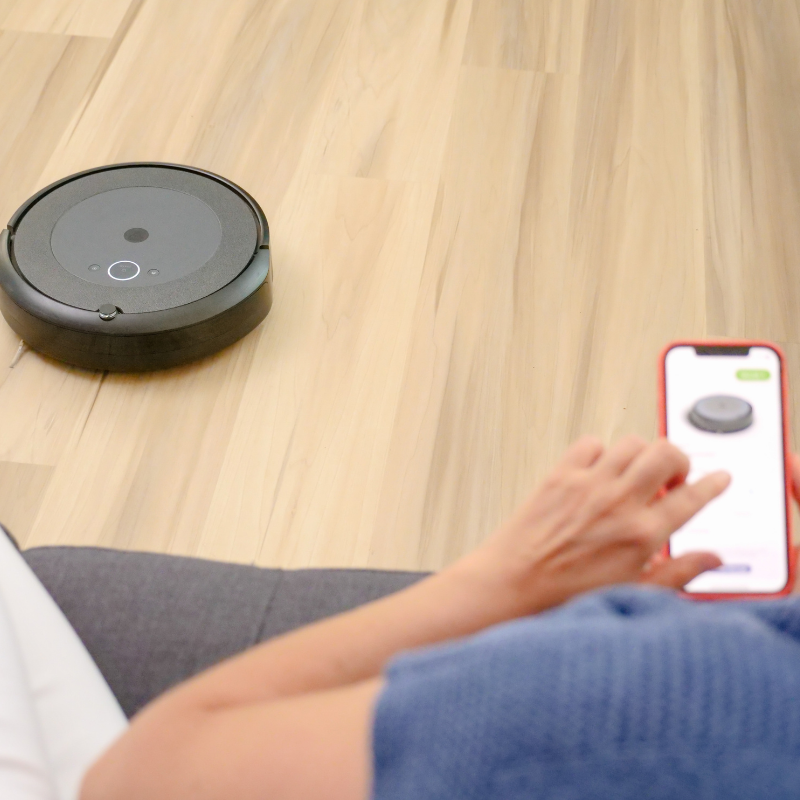 electronics grid 6 someone controlling an automatic home vacuum