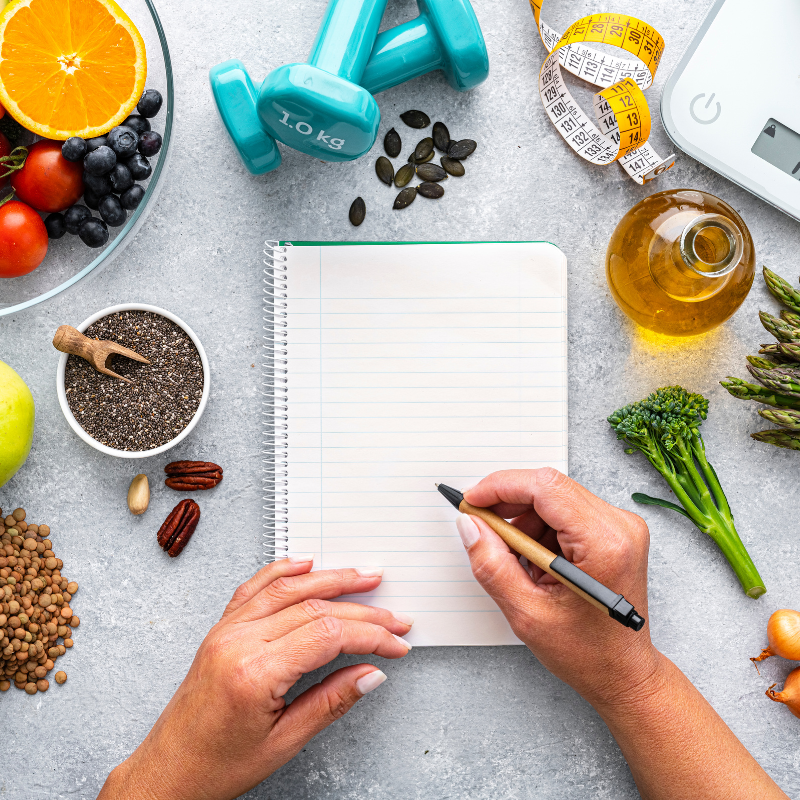 person making notes on wellness