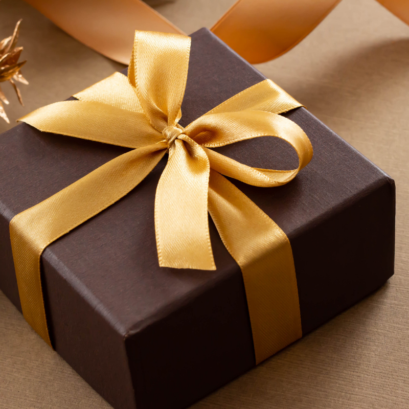 gifting grid 1 gift box wrapped in gold ribbon
